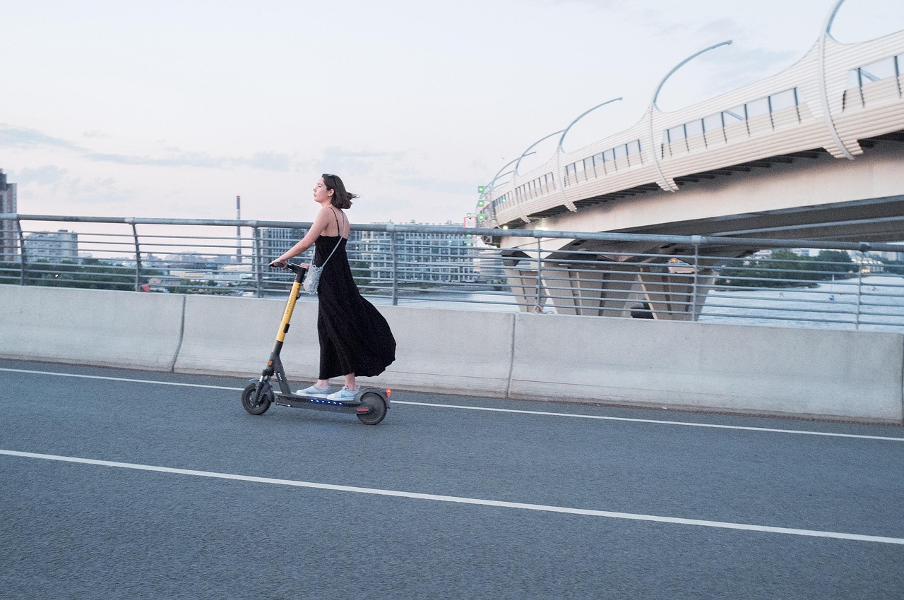 Woman, electric scooter, street — Medical Information Age - Bio-Nick and M2M Technology